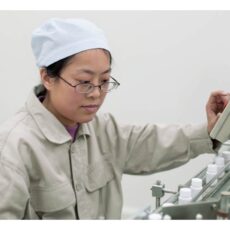 Pharmaceutical factory worker monitoring production line in a modern facility in China, showcasing innovation and technology in the pharmaceutical industry.